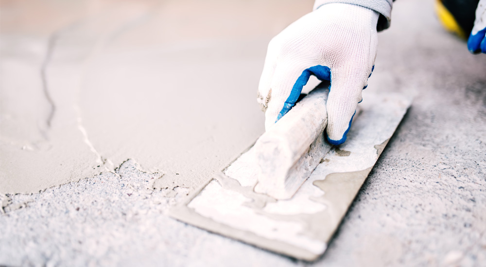 Applying mud to cracks in foundation